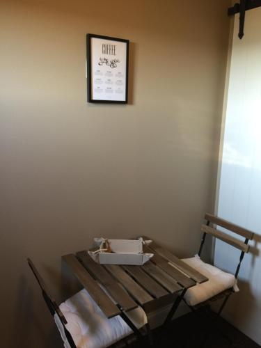 a room with a table with a box on the wall at Bed and Breakfast Bobilou in Kalmthout