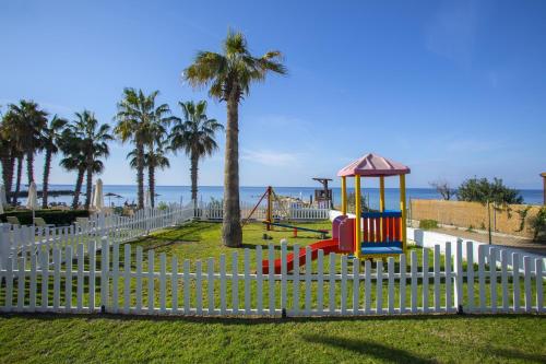 a playground at the beach with palm trees at Louis Ledra Beach in Paphos City
