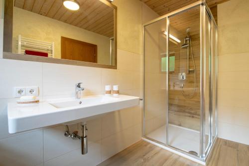 a bathroom with a sink and a shower at Appartmenthaus Martina in Zell am Ziller