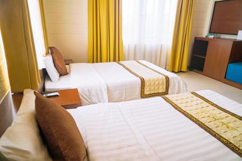 Giường trong phòng chung tại Dai A Hotel