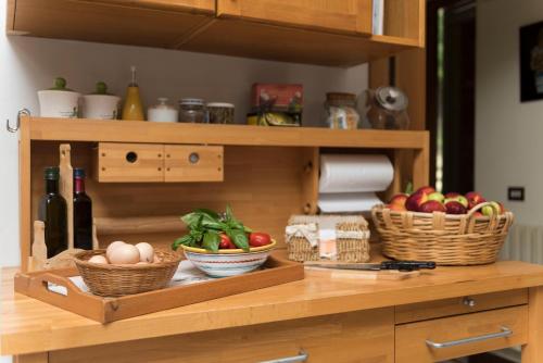 a shelf with baskets of fruits and vegetables on it at B&B Albachiara Casa di Campagna in Ogliastro Cilento