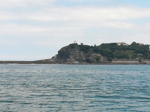 an island in the middle of a body of water at Lake House St Pee Sur Nivelle in Saint-Pée-sur-Nivelle