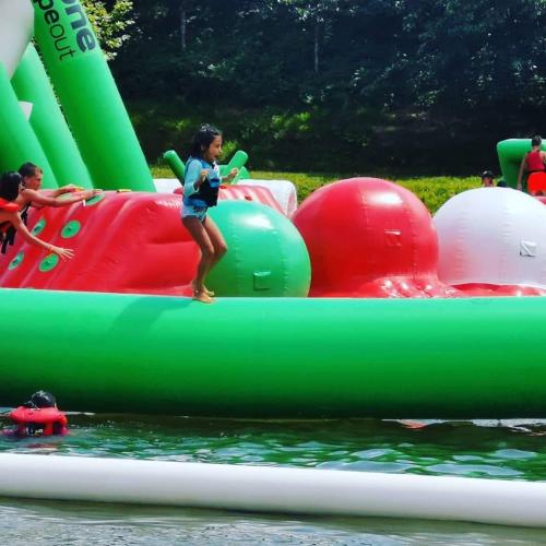 a young girl riding on a inflatable raft in the water at Lake House St Pee Sur Nivelle in Saint-Pée-sur-Nivelle