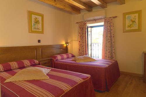 Postel nebo postele na pokoji v ubytování Hotel Jacobeo
