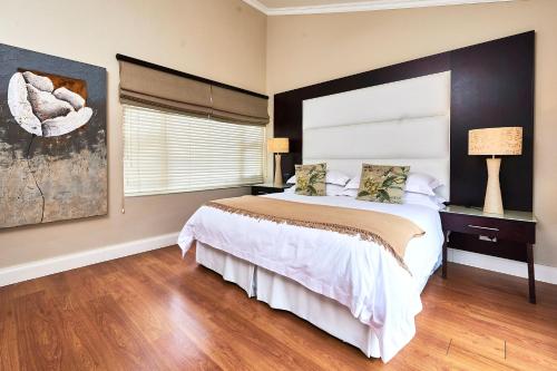 a bedroom with a large bed and a window at Forest Manor Boutique Guesthouse in Durban