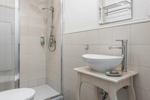 a bathroom with a sink and a shower at Lu Apartments in Oświęcim