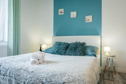a bedroom with a large bed with towels on it at Lu Apartments in Oświęcim
