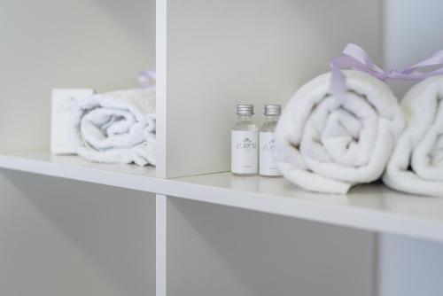 a shelf with towels and bottles on it at Lu Apartments in Oświęcim