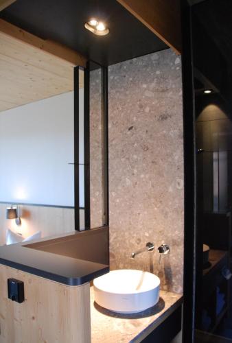 a bathroom with a white sink and a mirror at Gasthof-Hotel Höhensteiger in Rosenheim