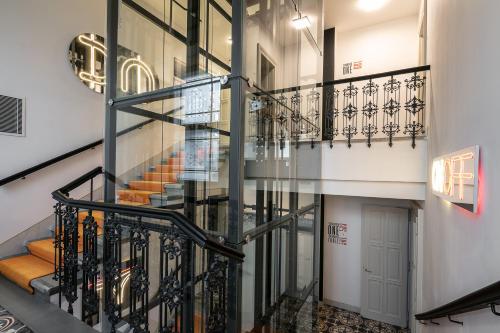 a spiral staircase in a building with glass walls at MeetMe23 in Prague