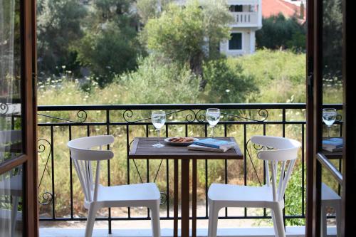 a table and chairs on a balcony with a view at Sti Chora Apartments in Lefkada Town