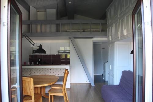 uma cozinha e sala de jantar com uma cama alta em STUDIO CHAMONIX MONT-BLANC Idéalement situé em Chamonix-Mont-Blanc