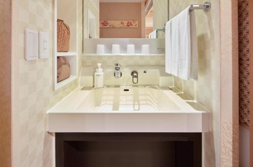 a bathroom with a white sink in a room at HOTEL MYSTAYS Asakusabashi in Tokyo