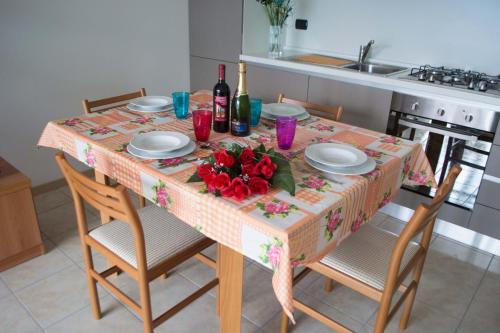 a table with plates and flowers on it in a kitchen at Residence Dorio in Dorio