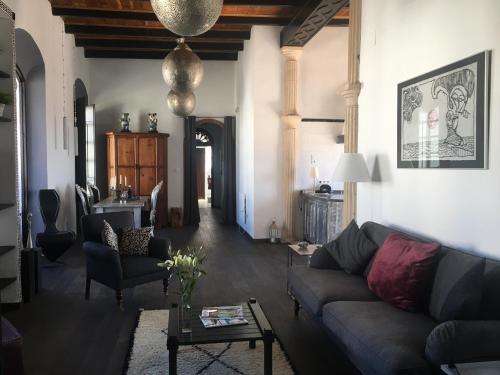 a living room with a couch and a table at Darcilla Guest House in Tarifa