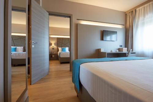 a hotel room with a large bed and a bedroom at DC HOTEL INTERNATIONAL in Padova
