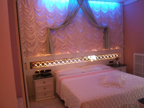 a bedroom with a bed and a large mirror at Hotel Matilde in Marina di Massa