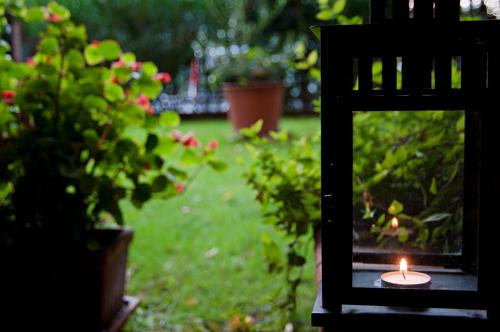 a candle sitting on a table in a garden at eco Hotel Milano & BioRiso Restaurant in Milan