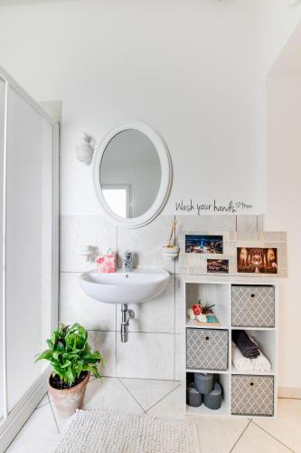 a bathroom with a sink and a mirror at Campus House in Forlì