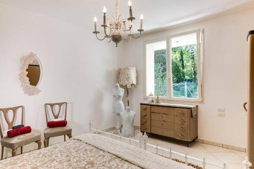a bedroom with a bed and two chairs and a window at Campus House in Forlì
