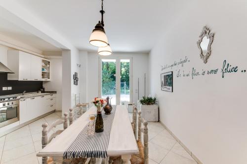 a kitchen with a long table with chairs and a table sidx sidx sidx at Campus House in Forlì