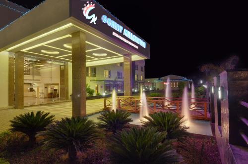 a building with a sign on it at night at GeeKay Millenniaa in Vellore