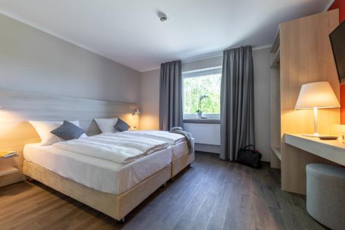 Ένα ή περισσότερα κρεβάτια σε δωμάτιο στο Serways Hotel Waldmohr