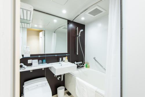 a bathroom with a sink, toilet and bathtub at La'gent Hotel Shinjuku Kabukicho in Tokyo