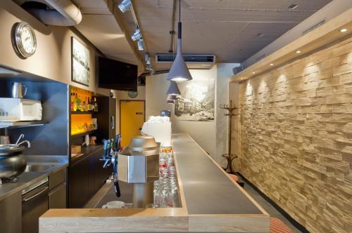 a bar in a kitchen with a counter top at Hotel Kreuz & Post Grindelwald in Grindelwald