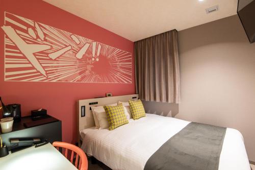a bedroom with a bed and a painting on the wall at La'gent Hotel Shinjuku Kabukicho in Tokyo