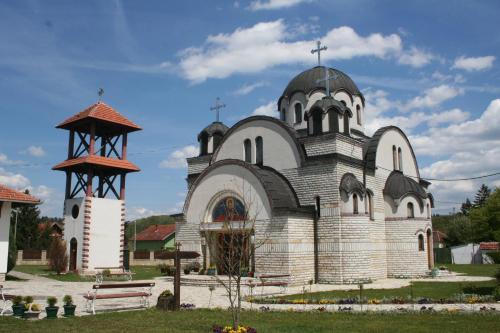 a church with two crosses on top of it at Apartmani Centar Banja Vrujci in Mionica