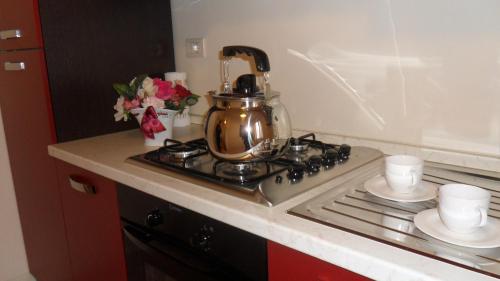 a tea kettle sitting on top of a stove in a kitchen at Tre Girasoli in Monte San Savino