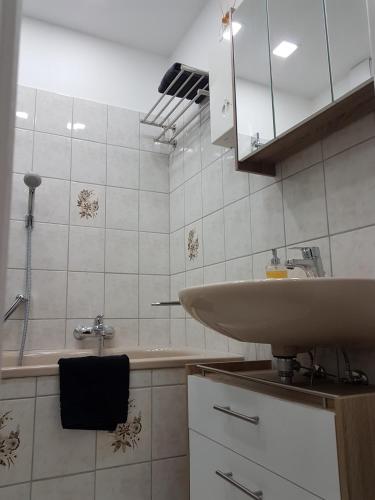 a bathroom with a sink and a mirror at Apartment Alt-Refrath in Bergisch Gladbach