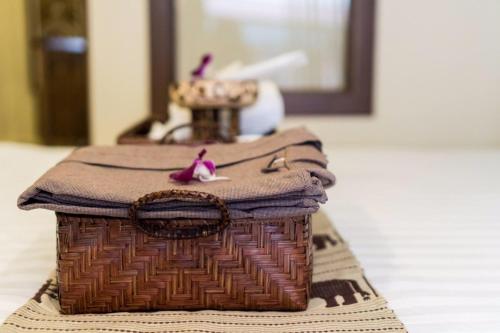 a wicker basket sitting on top of a table at Wannamas Chiangmai Boutique House -SHA Extra Plus in Chiang Mai