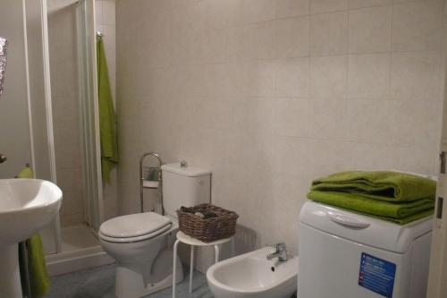 bagno con servizi igienici bianchi e lavandino di Casa Gemma a Lucca