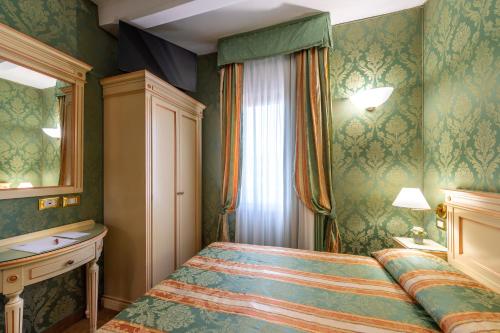 Ένα ή περισσότερα κρεβάτια σε δωμάτιο στο Hotel Villa Delle Palme
