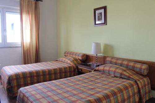 Tempat tidur dalam kamar di Mafra Guest House