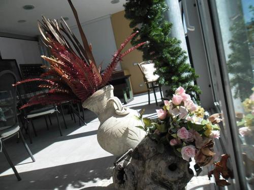 a large white vase with flowers in a room at Agritur Leita in Tuenno