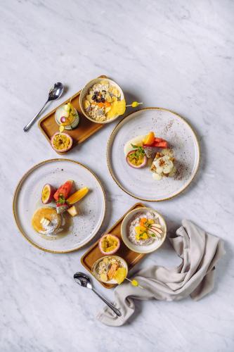 a group of plates of food on a table at Tastoria Collection Sukhumvit in Bangkok