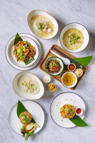 a group of plates of food on a table at Tastoria Collection Sukhumvit in Bangkok