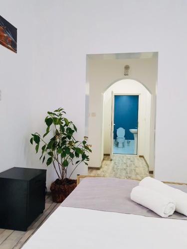 a white room with a bed and a bathroom at kessane in Akhaltsikhe