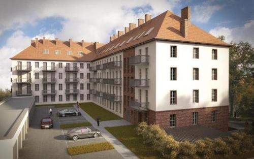a rendering of a building with a car parked in a parking lot at Apartament 444 Apartamenty No.1 in Szczecin