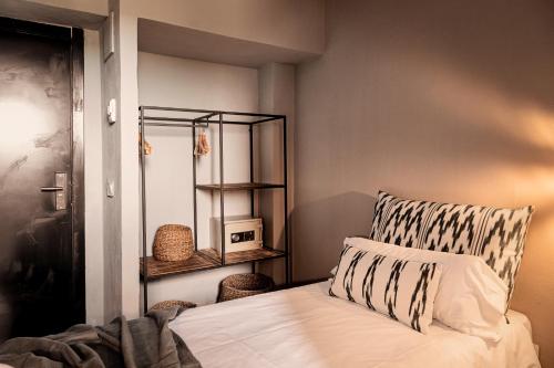 um quarto com uma cama com uma almofada e uma prateleira em Cooks Club Palma Beach - Adults Only em Playa de Palma