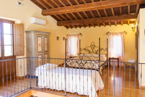 a bedroom with a bed in a room at Podere Caldaruccio La Pineta in Bosco
