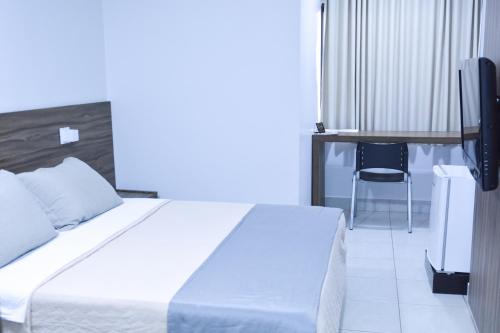 Ένα ή περισσότερα κρεβάτια σε δωμάτιο στο Planaltos Palace Hotel