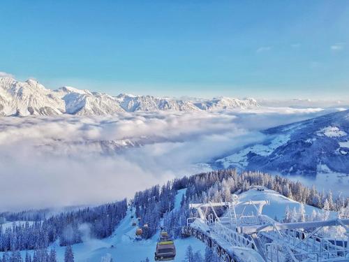 a view of a snowy mountain with a ski lift at Die Frida by Da Alois - Alpine Premium Apartments in Gröbming