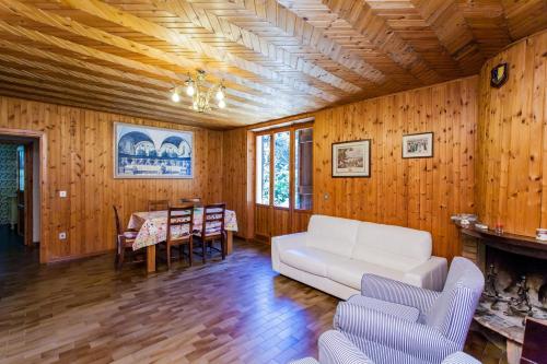 a living room with a white couch and a table at Podere Caldaruccio La Pineta in Bosco