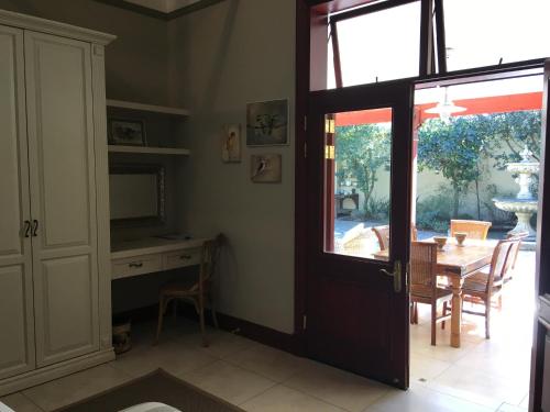a dining room with a table and a sliding door at The Courtyard at La Loggia in Nottingham Road