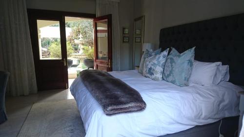 a bedroom with a bed with a blanket on it at The Courtyard at La Loggia in Nottingham Road