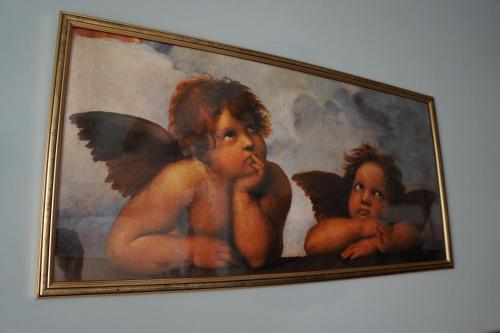 a painting of two angels on a wall at LA BRIGATA APARTMENTS Suite Room in Cavallino-Treporti